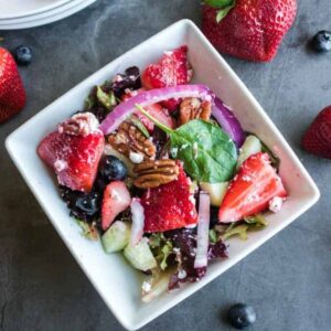 strawberry pecan salad in a white bowl