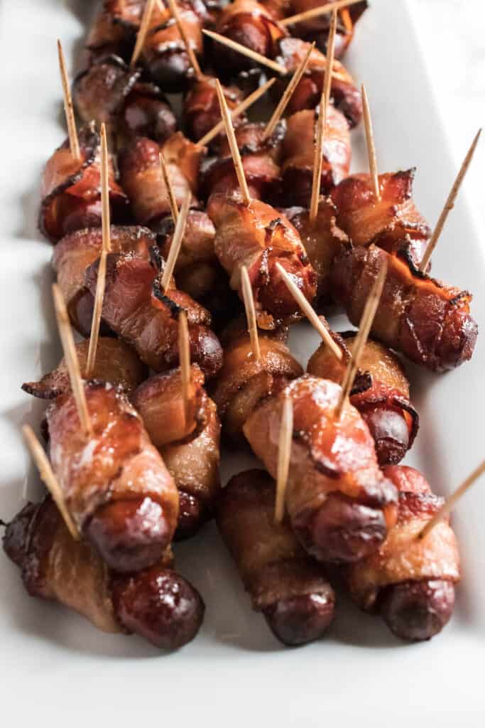 Learn How To Make Air Fryer Bacon Wrapped Smokies - Air Fryer Bacon Wrapped Smokies are a game-changer! They are much easier than in the oven and will "WOW" your party guests. Try them and see for yourself. #bacon #wrappedsmokies #appetizer #partyfood #easy #homefreshideas