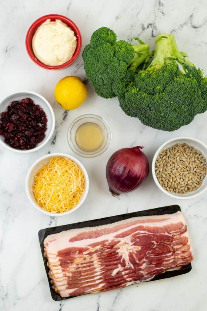 ingredients for homemade broccoli salad on marble counter 