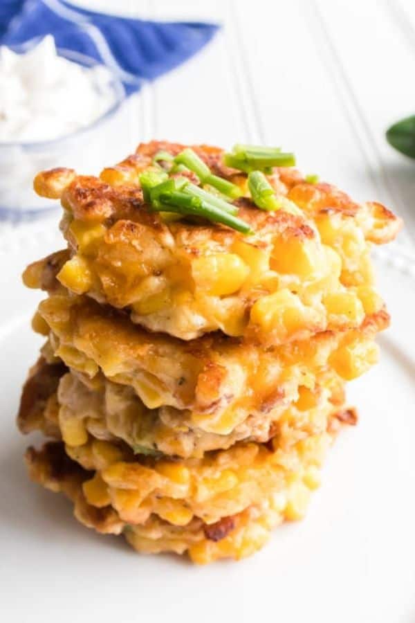 stack of 5 corn fritters on plate.