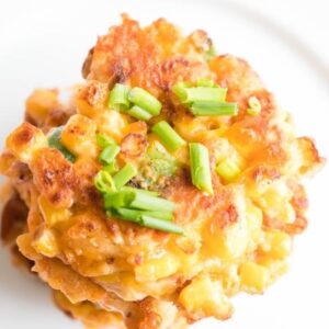 plate with several corn fritters stacked.