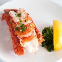 plate with a cooked lobster tail.