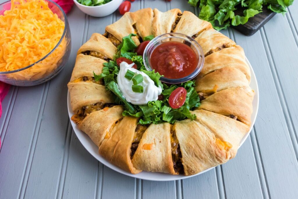taco ring with lettuce, tomatoes, and salsa
