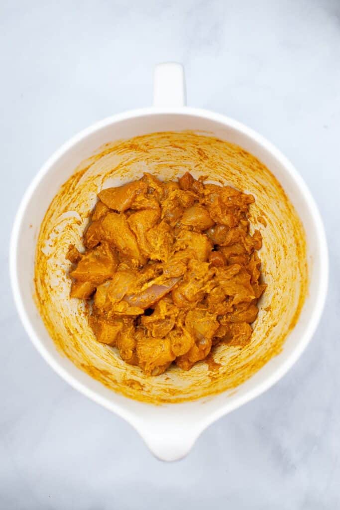bowl with tandoori chicken marinating
