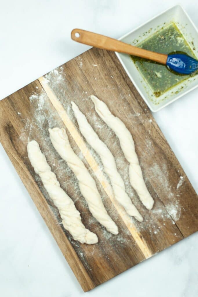 rolling out breadstick dough