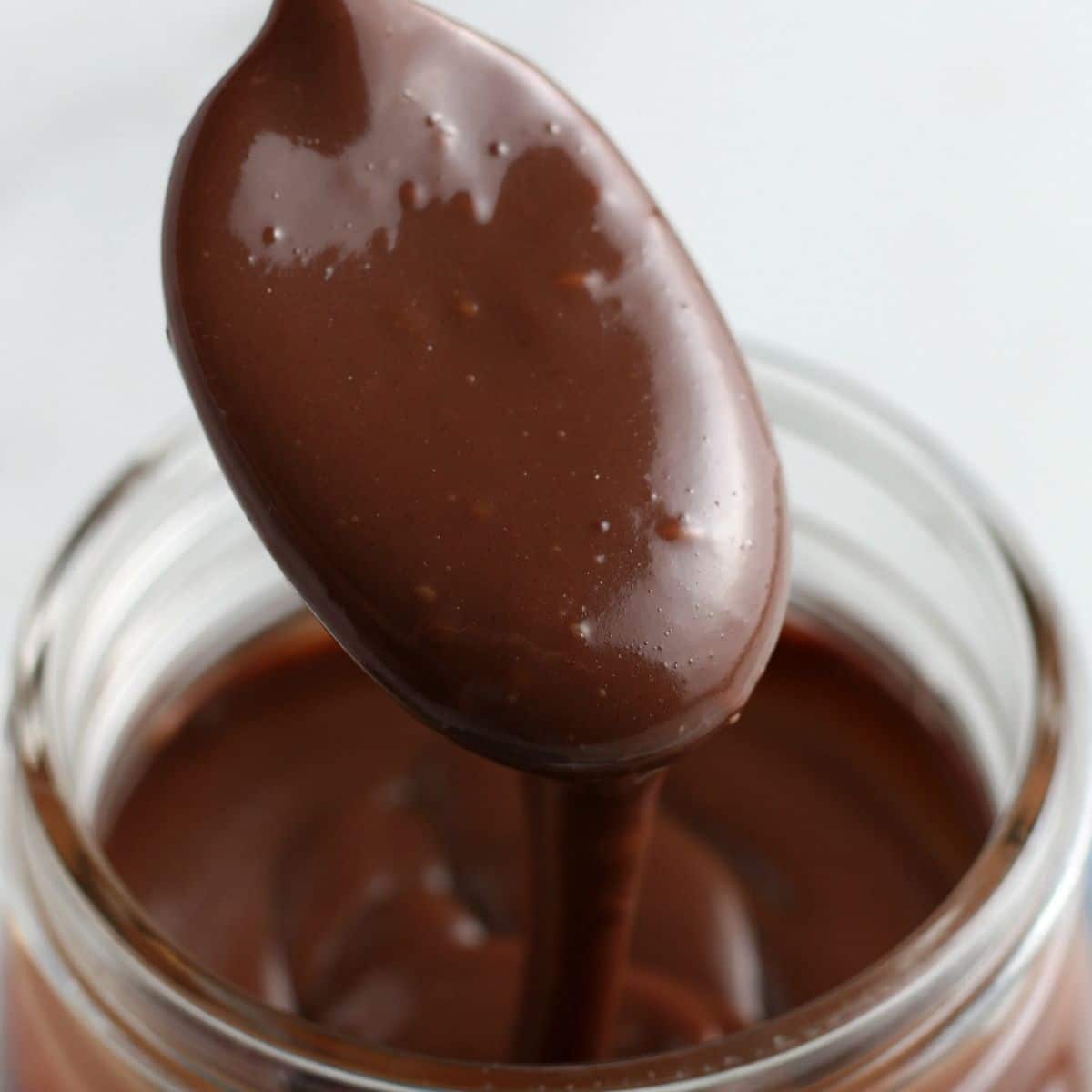 hot fudge dripping off of spoon