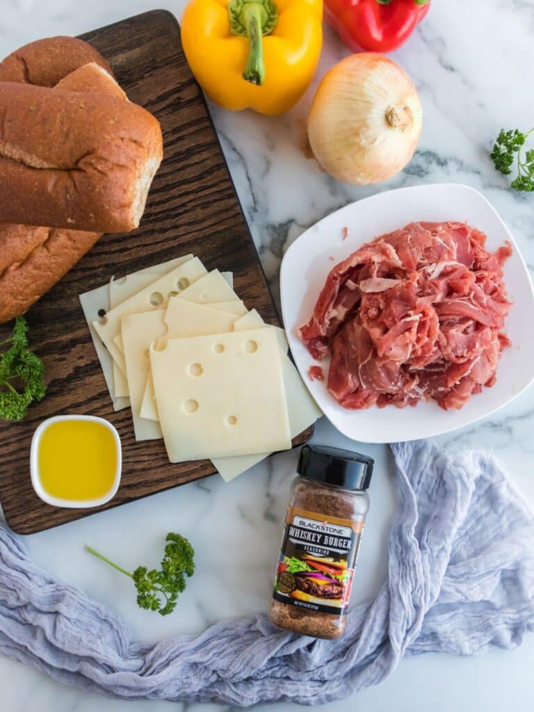 ingredients to make a shredded beef cheesesteak