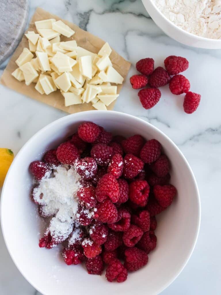 fresh raspberries in a bowl with sugar