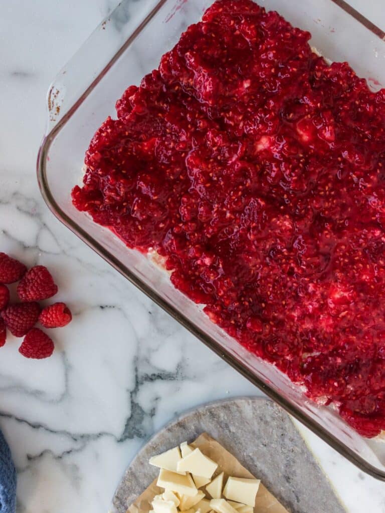 layer of raspberries on top of shortbread cookie