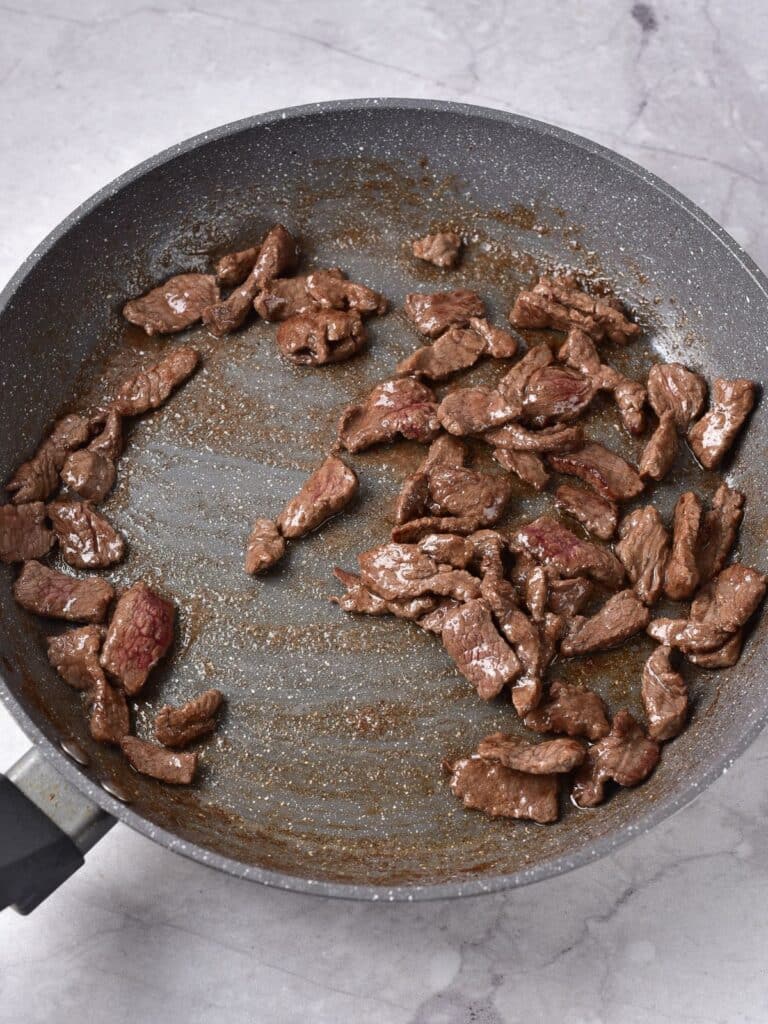 cooking steak in skillet