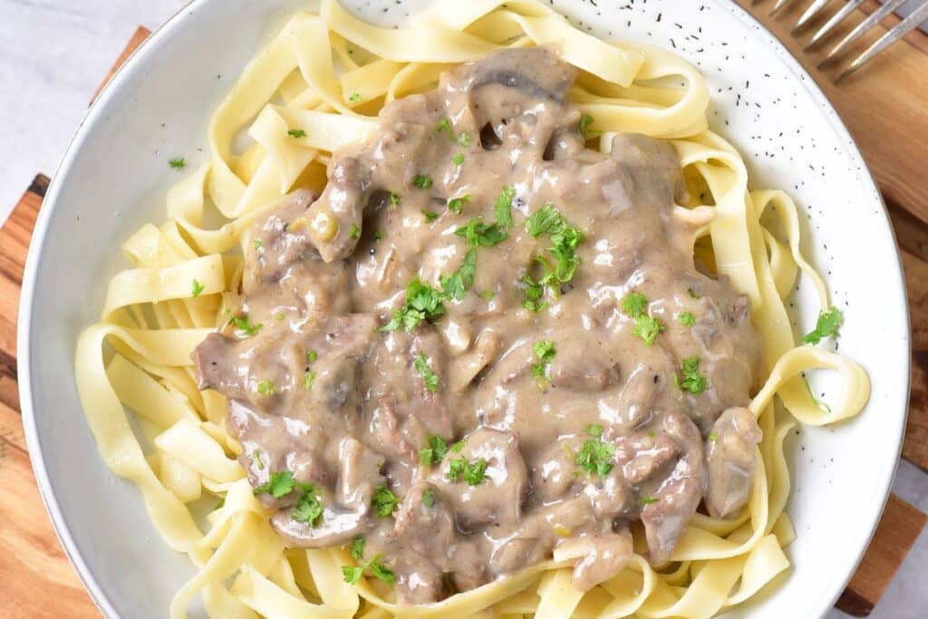 white plate with creamy beef stroganoff